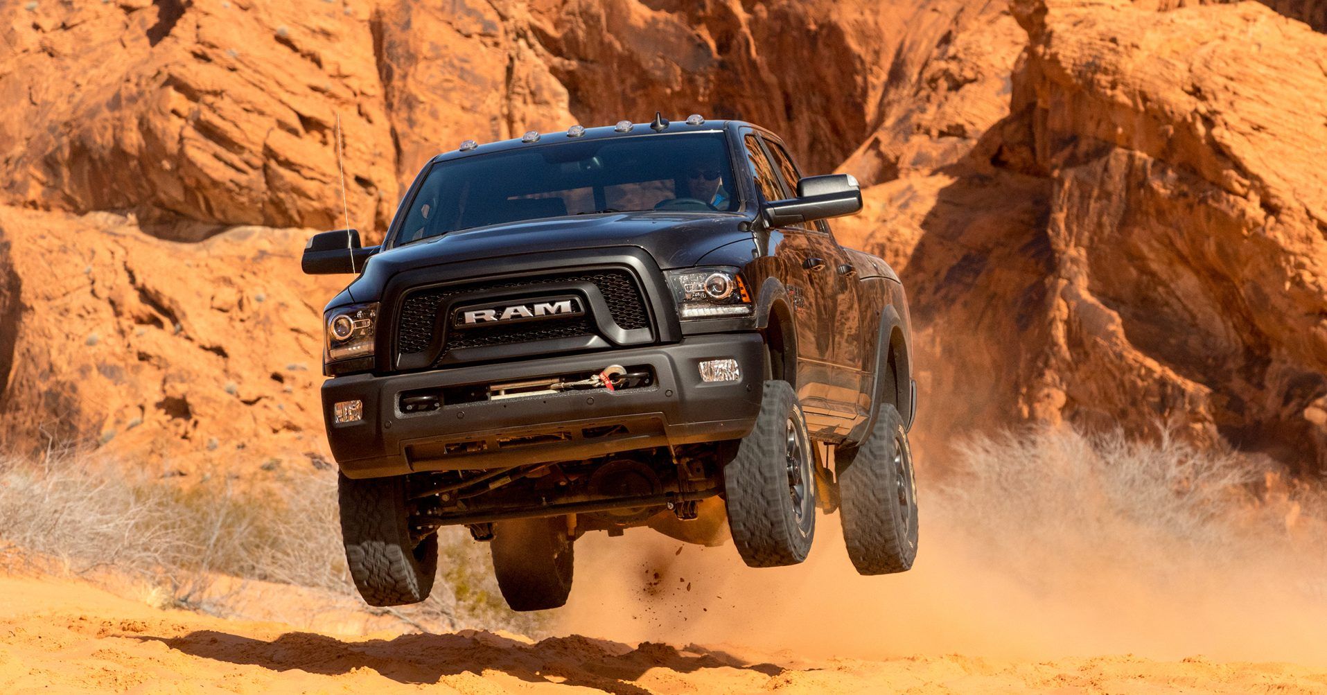 Diesel armored pickup climbing rocky desert terrain