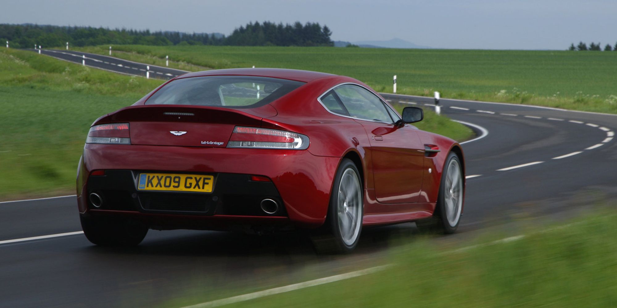 The rear of a red V12 Vantage on the move