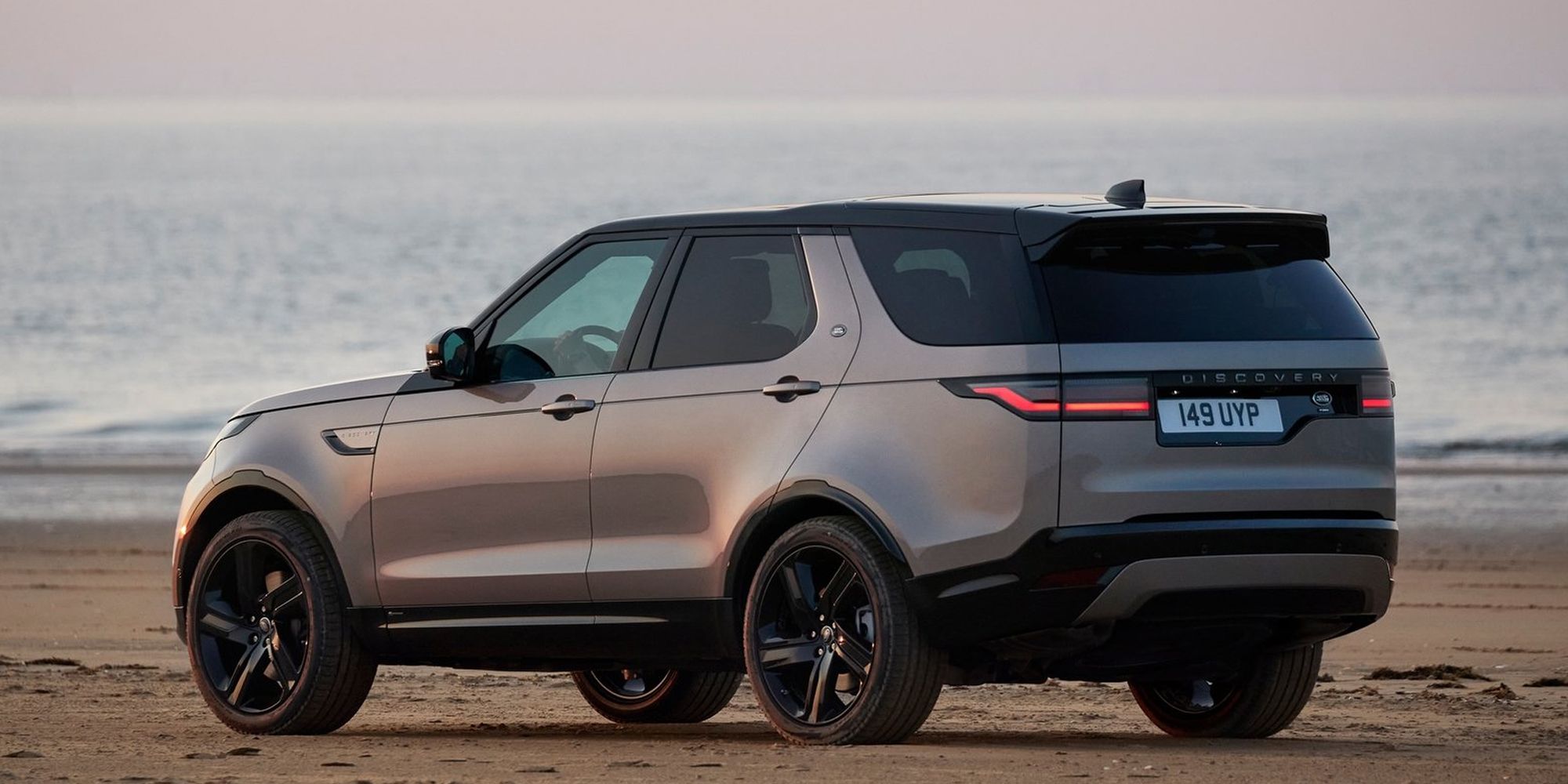 Rear 3/4 view of a Discovery on sand, static