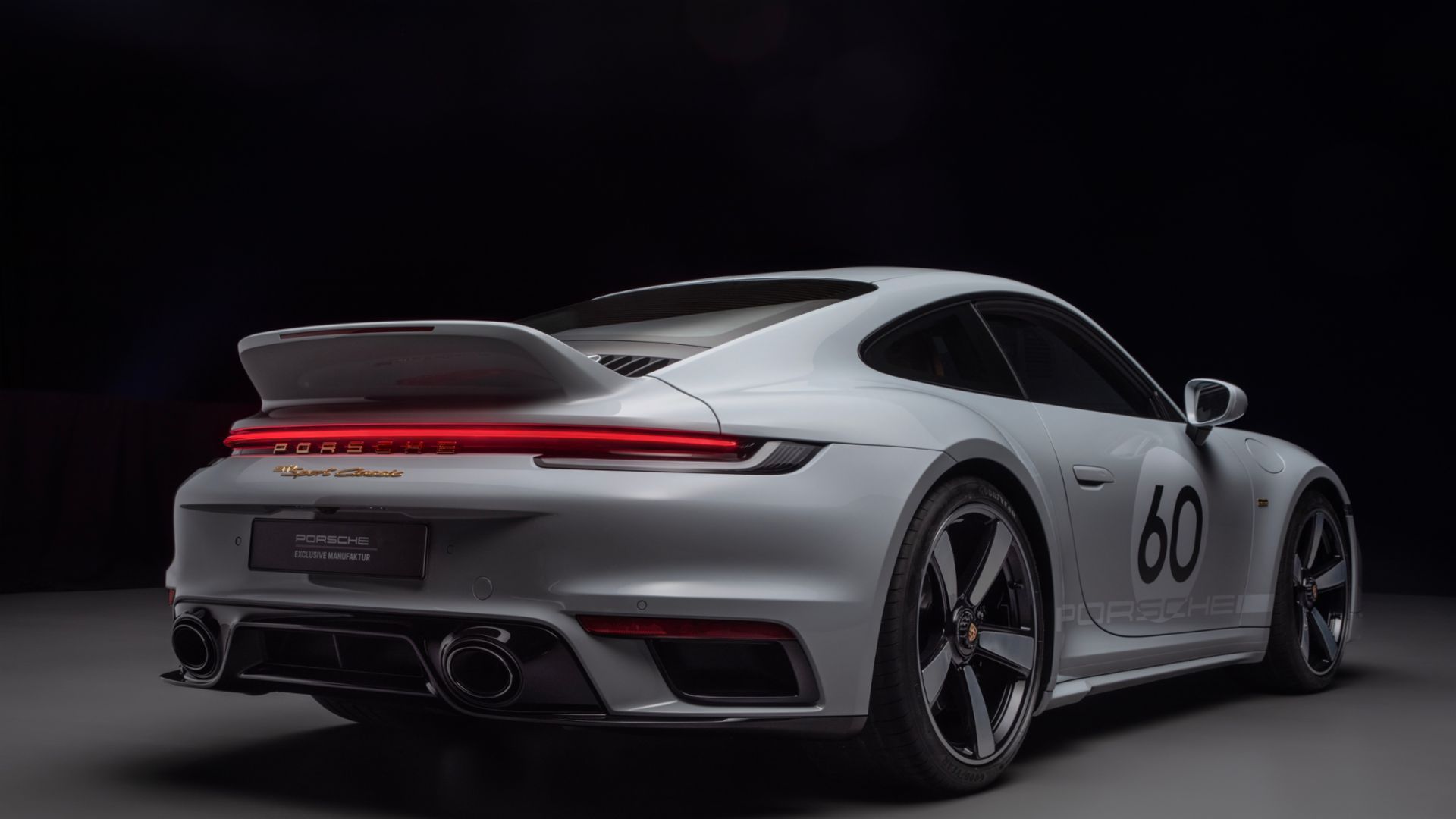 2023 Porsche 911 Sport Classic, silver, rear quarter view, dark backdrop