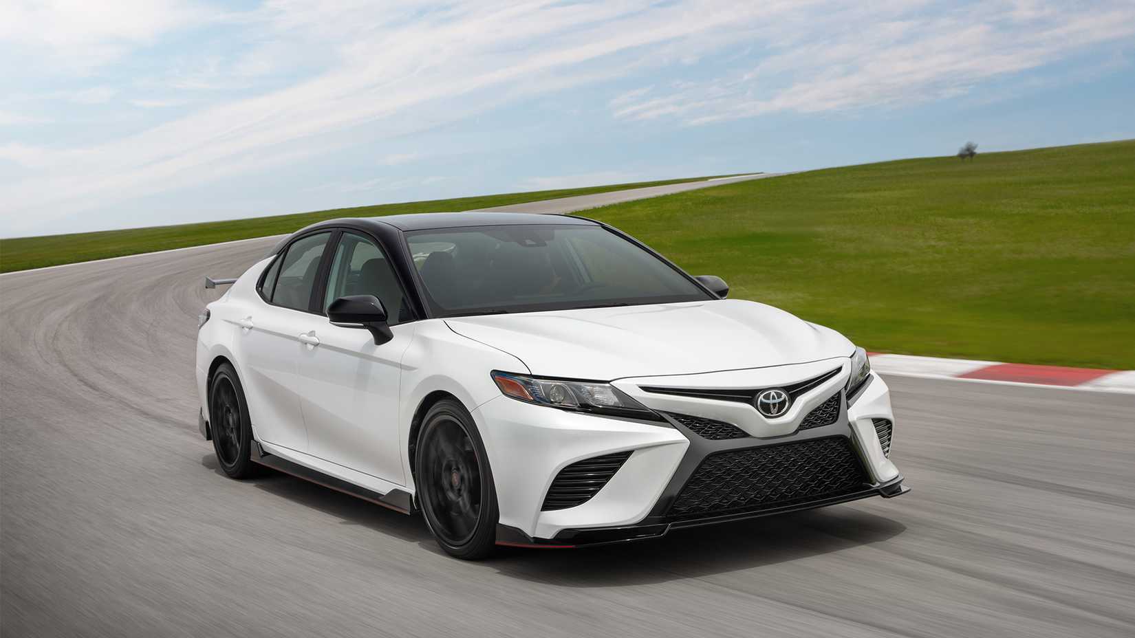 front 3/4 shot of a white 2024 Toyota Camry TRD driving on track