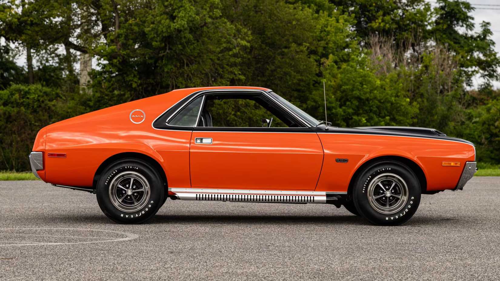 Side view of a parked 1970 AMC AMX finished in Big Bad Orange