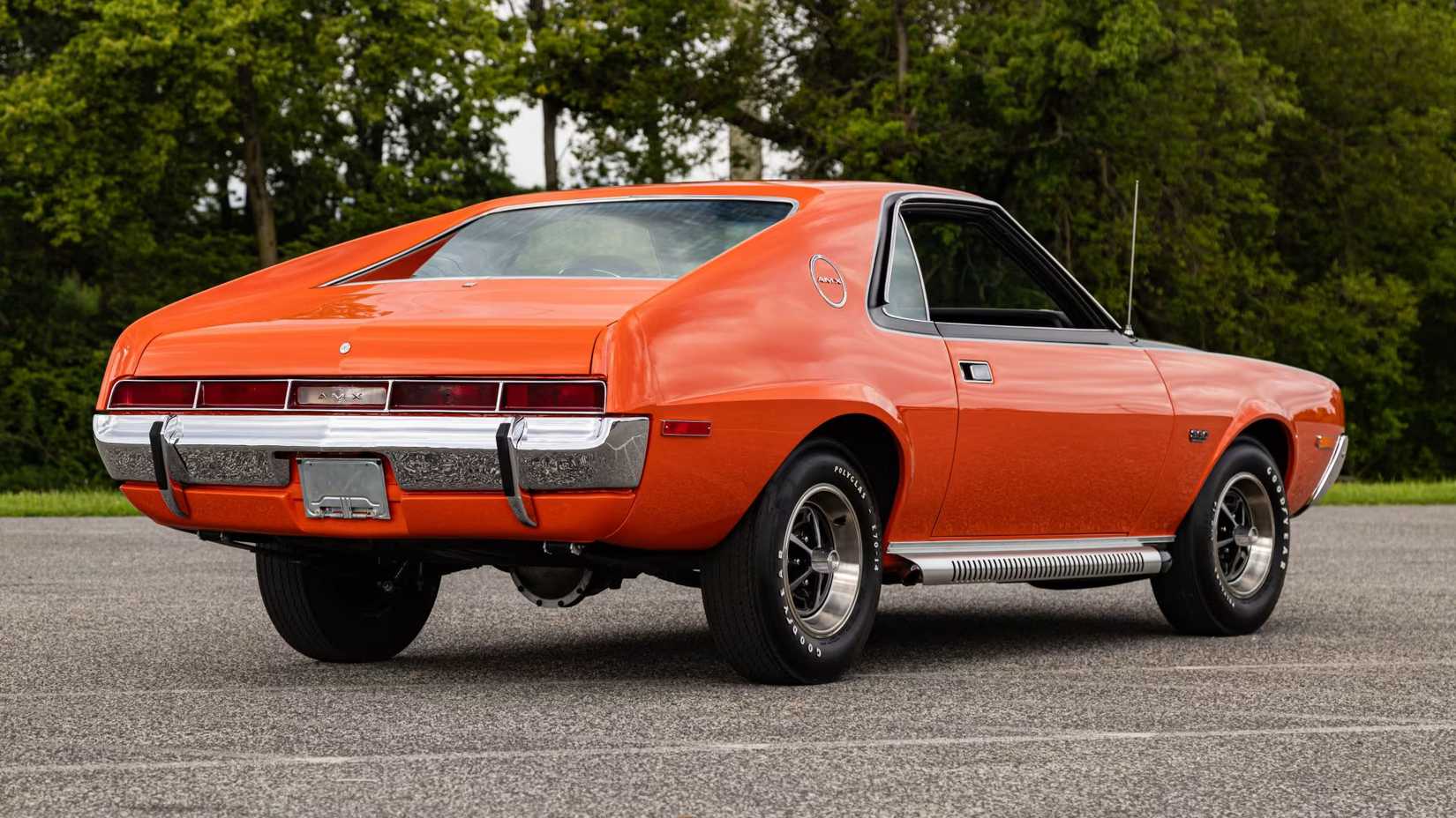 Rear three-quarter view of a parked 1970 AMC AMX finished in Big Bad Orange
