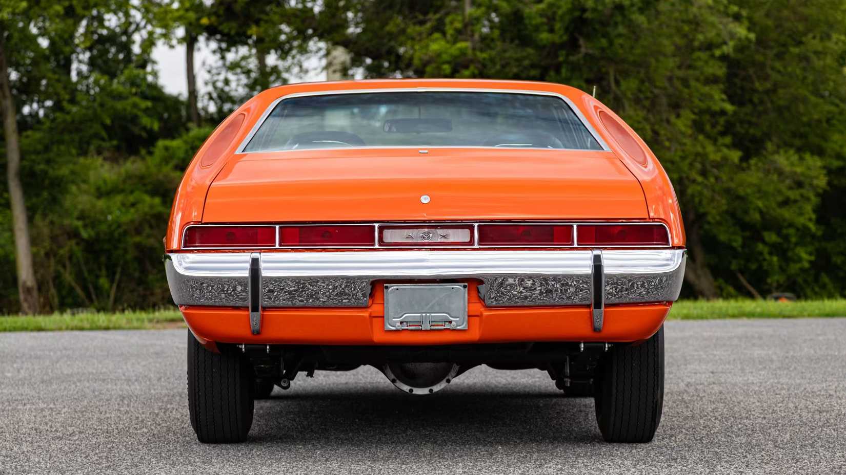 Rear view of a parked 1970 AMC AMX finished in Big Bad Orange